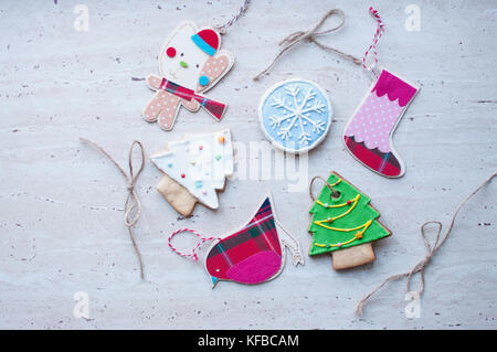 Diversity of Christmas toys - the flat wooden and textile toys and the gingerbread cookies in the different shapes. Stock Photo