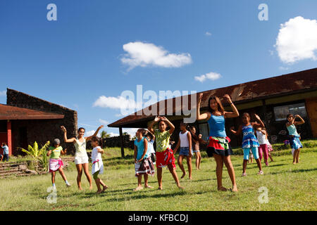 EASTER ISLAND, CHILE, Isla de Pascua, Rapa Nui, children playing and learning traditional dances on the lawn Stock Photo