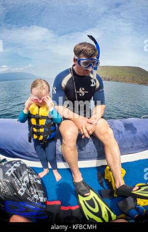 GALAPAGOS ISLANDS, ECUADOR, individuals getting ready to go snorkeling in the waters near Tagus Cove Stock Photo