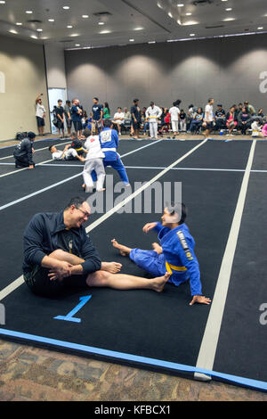 USA, Oahu, Hawaii, Jujitsu Martial Arts fighter Keith Chang and his nephew streatch before they grapple at the ICON grappling tournament in Honolulu Stock Photo