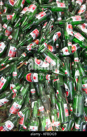 Beer Rings Polution Pile of empty green beer bottles thrown away on a beach illustrate ...