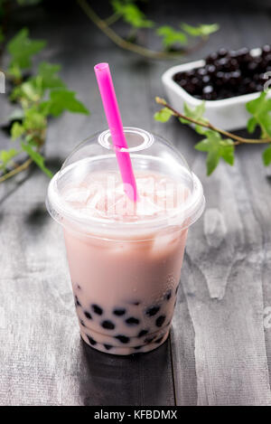 Bubble boba tea with milk and tapioca pearls in plastic cup Stock Photo