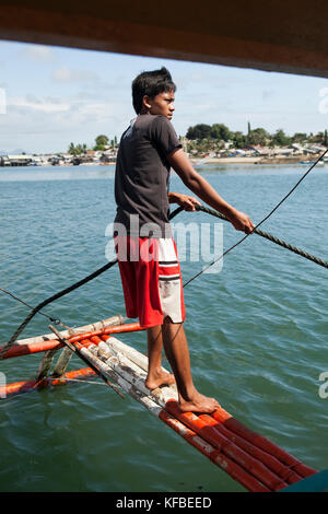 PHILIPPINES, Palawan, Puerto Princessa, portrait of a fisherman in front of his boat in the City Port Area Stock Photo