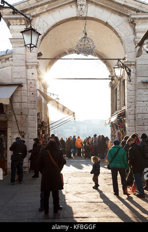ITALY, Venice. Tourists on the Rialto Bridge enjoying the view of the Grand Canal. Stock Photo