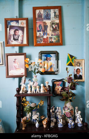 JAMAICA, Port Antonio. Family photos on a wall inside a local home. Stock Photo