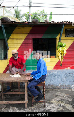 JAMAICA, Port Antonio. Joseph 'Powder' Bennett and Derrick 'Johnny' Henry of the Mento band, The Jolly Boys playing dominoes at the Willow Wind Bar. Stock Photo