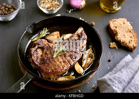 Roasted pork steak in frying pan. Fried meat Stock Photo