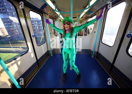 London, UK. 27th Oct, 2017. Participant dressed as the Riddler enjoys a ride on the London DLR on the way to MCM London Comic Con taking place at Excel Credit: Paul Brown/Alamy Live News Stock Photo