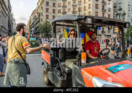 October 27, 2017 - Barcelona, Catalonia, Spain - The locals seen giving handshake to the farmer with the tractor.  Farmers Union tractor passes in front of the headquarters of the Spanish national police to join the party that takes place in PlaÃ§a de Sant Jaume.Few hours after the President Carles Puigdemont announced the independence of Catalonia, several tractors of the Union of farmers have joined the party to celebrate the Declaration of the new Catalan Republic.  Meanwhile , a large crowd of people have taken the plaza Sant Jaume in Barcelona, headquarters of the Generalitat de Catalunya Stock Photo