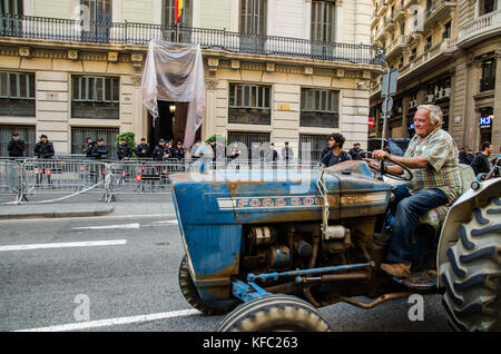 October 27, 2017 - Barcelona, Catalonia, Spain - Farmers Union tractor passes in front of the headquarters of the Spanish national police to join the party that takes place in PlaÃ§a de Sant Jaume.Few hours after the President Carles Puigdemont announced the independence of Catalonia, several tractors of the Union of farmers have joined the party to celebrate the Declaration of the new Catalan Republic.  Meanwhile , a large crowd of people have taken the plaza Sant Jaume in Barcelona, headquarters of the Generalitat de Catalunya, to celebrate the Declaration of independence  (Credit Image: © C Stock Photo