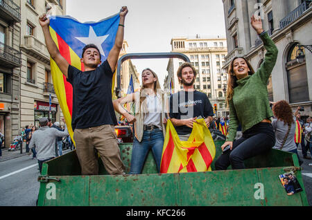 October 27, 2017 - Barcelona, Catalonia, Spain - Pro independence supporters seen getting a ride on the farmer's tractor. Farmers Union tractor passes in front of the headquarters of the Spanish national police to join the party that takes place in PlaÃ§a de Sant Jaume.Few hours after the President Carles Puigdemont announced the independence of Catalonia, several tractors of the Union of farmers have joined the party to celebrate the Declaration of the new Catalan Republic.  Meanwhile , a large crowd of people have taken the plaza Sant Jaume in Barcelona, headquarters of the Generalitat de Ca Stock Photo