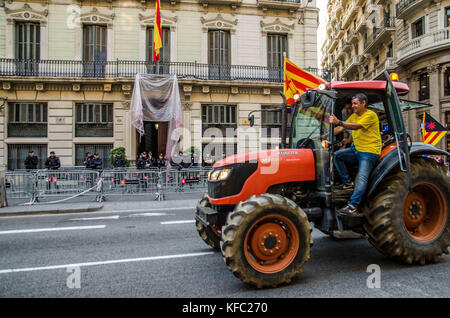October 27, 2017 - Barcelona, Catalonia, Spain - Farmers Union tractor passes in front of the headquarters of the Spanish national police to join the party that takes place in PlaÃ§a de Sant Jaume.Few hours after the President Carles Puigdemont announced the independence of Catalonia, several tractors of the Union of farmers have joined the party to celebrate the Declaration of the new Catalan Republic.  Meanwhile , a large crowd of people have taken the plaza Sant Jaume in Barcelona, headquarters of the Generalitat de Catalunya, to celebrate the Declaration of independence  (Credit Image: © C Stock Photo