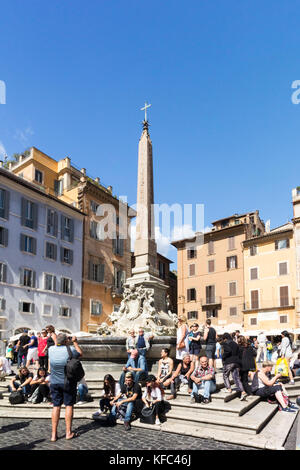 Tourists sitting by the Fontane del Pantheon, Piazza della Rotunda, Rome, Italy Stock Photo