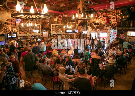 USA, Alaska, Juneau, individuals gather and dine inside of the Red Dog Saloon in downtown Juneau Stock Photo