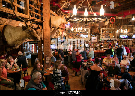 USA, Alaska, Juneau, individuals gather and dine inside of the Red Dog Saloon in downtown Juneau Stock Photo