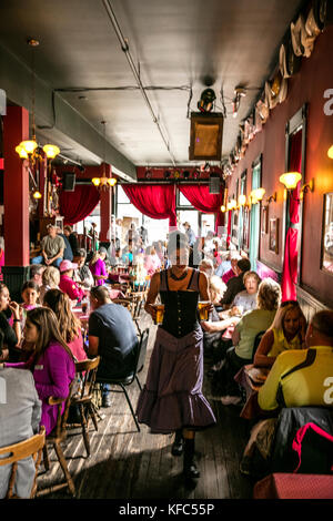 USA, Alaska, Sitka, guests take a break from walking around the streets of downtown Sitka to eat lunch at the Red Onion Saloon Stock Photo