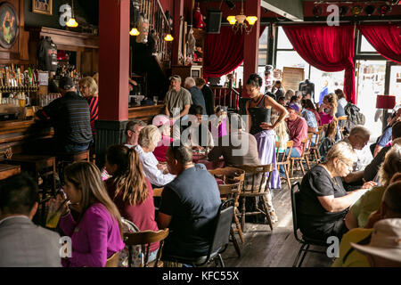 USA, Alaska, Sitka, guests take a break from walking around the streets of downtown Sitka to eat lunch at the Red Onion Saloon Stock Photo