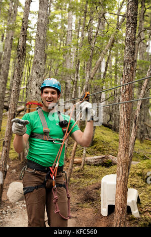 USA Alaska, Sitka, participants prepare for their 4-hour adventure where they will zip past massive spruce, cedars and glacially fed waterfalls, Grizz Stock Photo