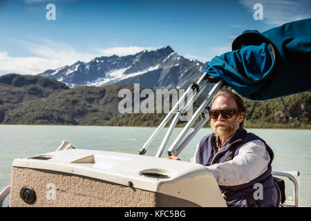 USA, Alaska, Redoubt Bay, Big River Lake, one of the bear biolgists driving the boat back from Wolverine Cove Stock Photo