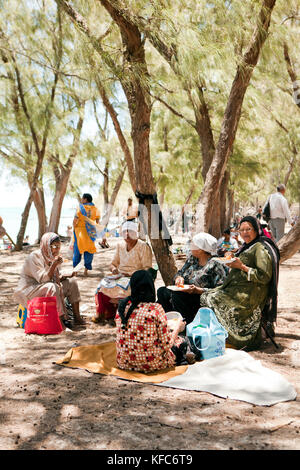 MAURITIUS, Muslim friends are having a picnic on the beach at Ile Aux Cerfs Island Stock Photo