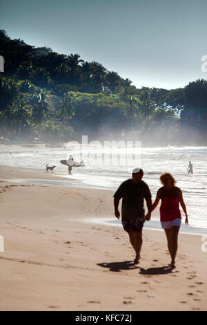 MEXICO, San Pancho, San Francisco, a couple walks hand in hand on San Pancho Beach Stock Photo