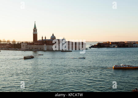 ITALY, Venice, Sunrise view of the Grand Canal with water taxis and the Chiesa di San Giorgio Maggiore. Stock Photo