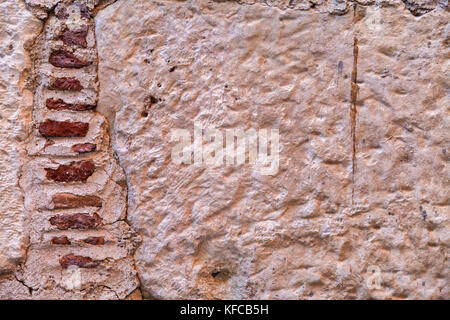Wall made of stones of different shapes and sizes. Background Stock Photo