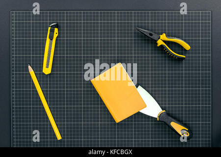Notebook and tools on graph paper Stock Photo