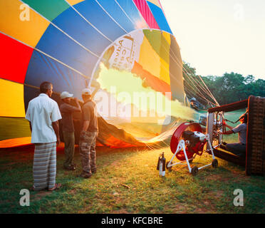 SRI LANKA, Asia, people operating a flame to fill a hot-air balloon Stock Photo