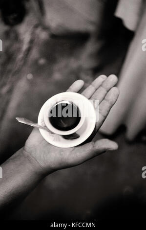 ERITREA, Massawa, a hand holding a small cup of coffee (B&W) Stock Photo