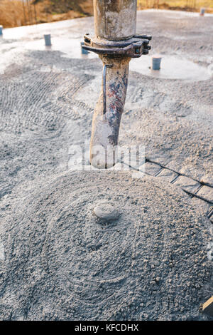 Concrete pouring during commercial concreting floors of buildings in construction - concrete slab Stock Photo