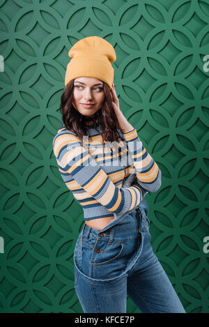 Woman posing in pullover, hat and overalls Stock Photo