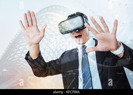 Pleasant excited man testing new technologies Stock Photo