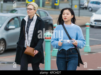 Young Asian woman walking in Brighton, East Sussex, England, UK. Stock Photo