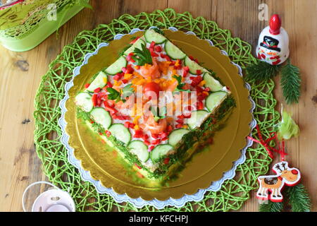 Swedish appetizer tart made with bread, smoked salmon, fresh cucumbers, soft cheese, sweet paprika, dill and cherry tomato Stock Photo