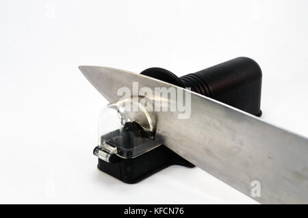 Manual knife sharpener with a stainless steel knife on a white background Stock Photo
