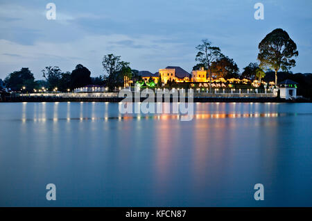 Astana Palace illuminated at night looking over Sarawak river in Kuching built by the White Rajah Charles Brooke in 1870. British colonial building Stock Photo