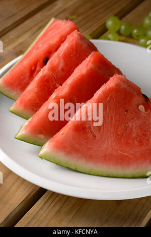 Watermelon slices on white plate - closeup Stock Photo