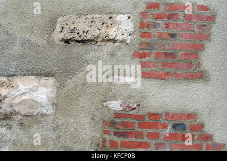 antique wall constructed with different materials Stock Photo