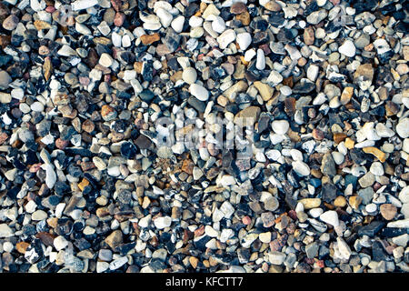 A lot of small white and dark stones. Stock Photo
