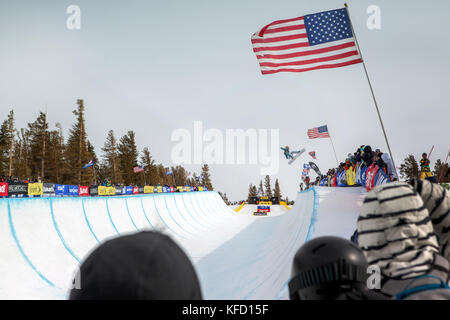 USA, California, Mammoth, a snowboarder launches out of the pipe during a competition at Mammoth Ski Resort Stock Photo