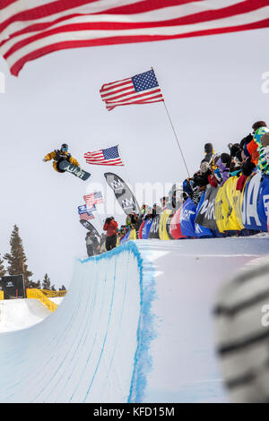 USA, California, Mammoth, a snowboarder launches out of the pipe during a competition at Mammoth Ski Resort Stock Photo