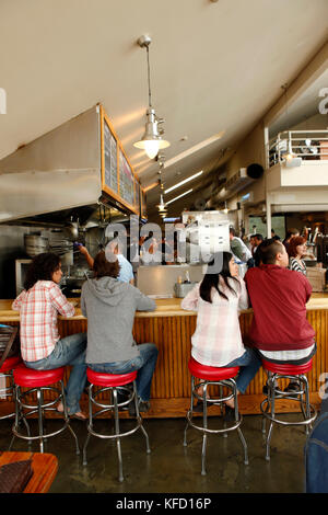 USA, California, Sausalito, guests sit on bar stools and eat lunch, Fish restaurant Stock Photo