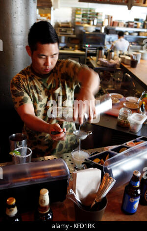 USA, California, Oakland, Chop Bar, Bartender preparing a Basil Gimlet Stock Photo