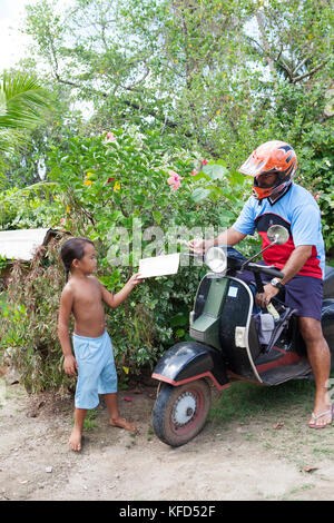 FRENCH POLYNESIA, Tahaa Island. The mailman delivering mail on Tahaa Island. Stock Photo