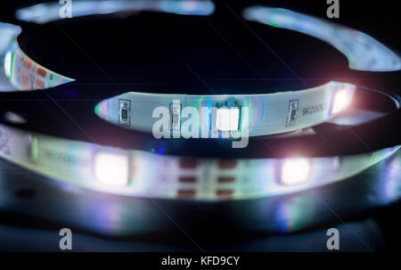 LED Light stripe in coil isolated on black and white backdrop, close up Stock Photo