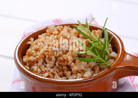 saucepan of cooked buckwheat on checkered dishtowel - close up Stock Photo