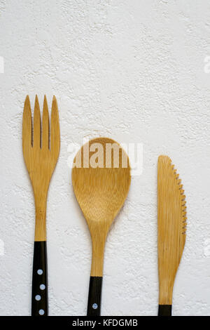 Bamboo fork, knife and spoon on white background closeup, Top view with copy space Stock Photo