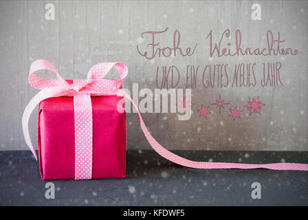 Gray Grungy Cement Wall With German Calligraphy Frohe Weihnachten Und Ein Gutes Neues Jahr Means Merry Christmas And Happy New Year. Pink Gift Or Pres