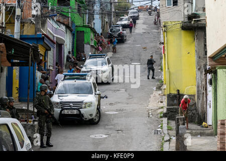Rio De Janeiro, Brazil. 27th Oct, 2017. Bystanders look on during operations in Rio De Janeiro's Sao Carlos Favela Friday, Oct. 27th, 2017. The operation conducted by over 1700 soldiers and police is aimed at capturing criminals involved in the cities ongoing violent narco-wars. Credit: C.H. Gardiner/Pacific Press/Alamy Live News Stock Photo